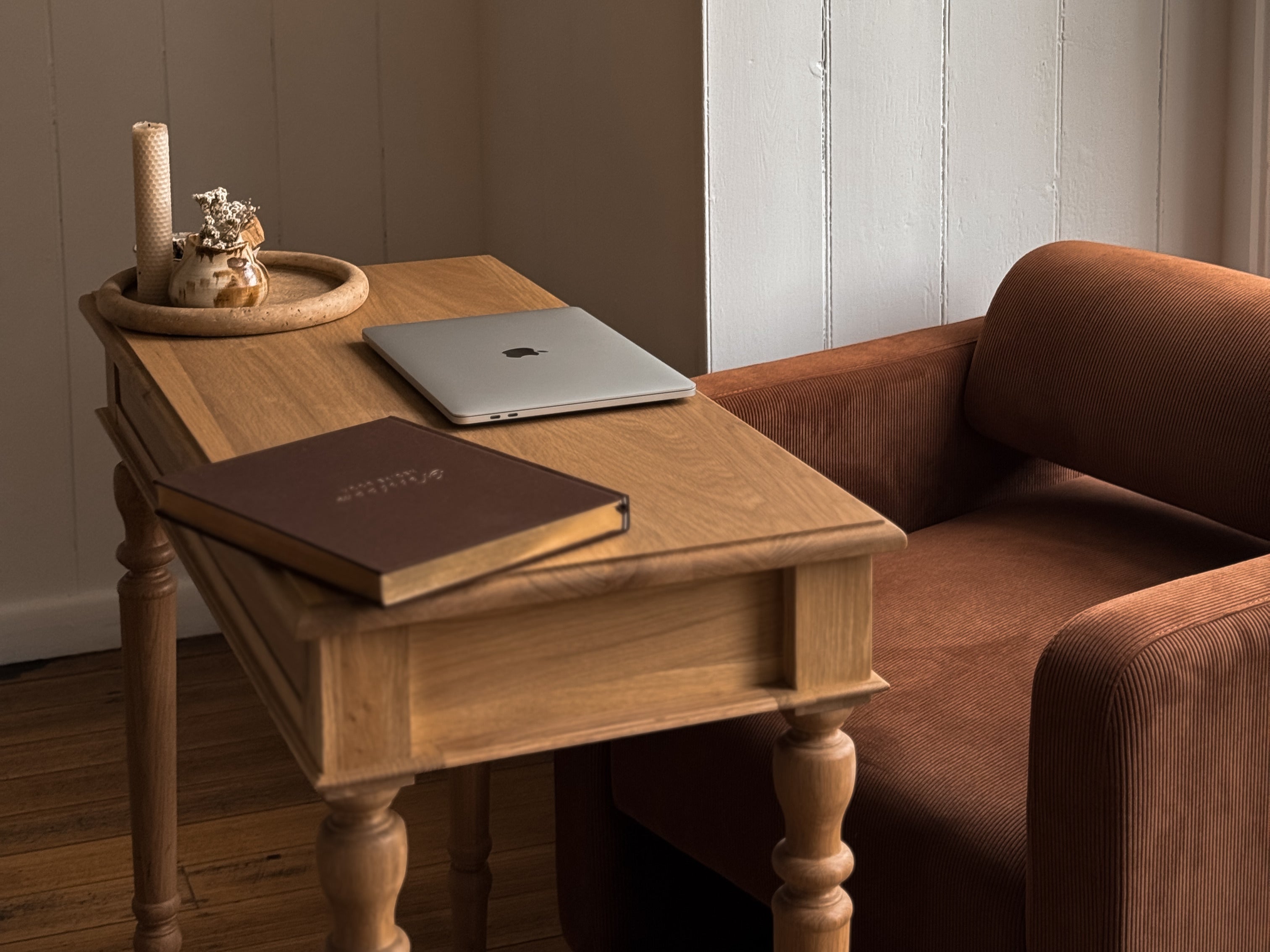 Chloe console in living room next to a chocolate brown armchair